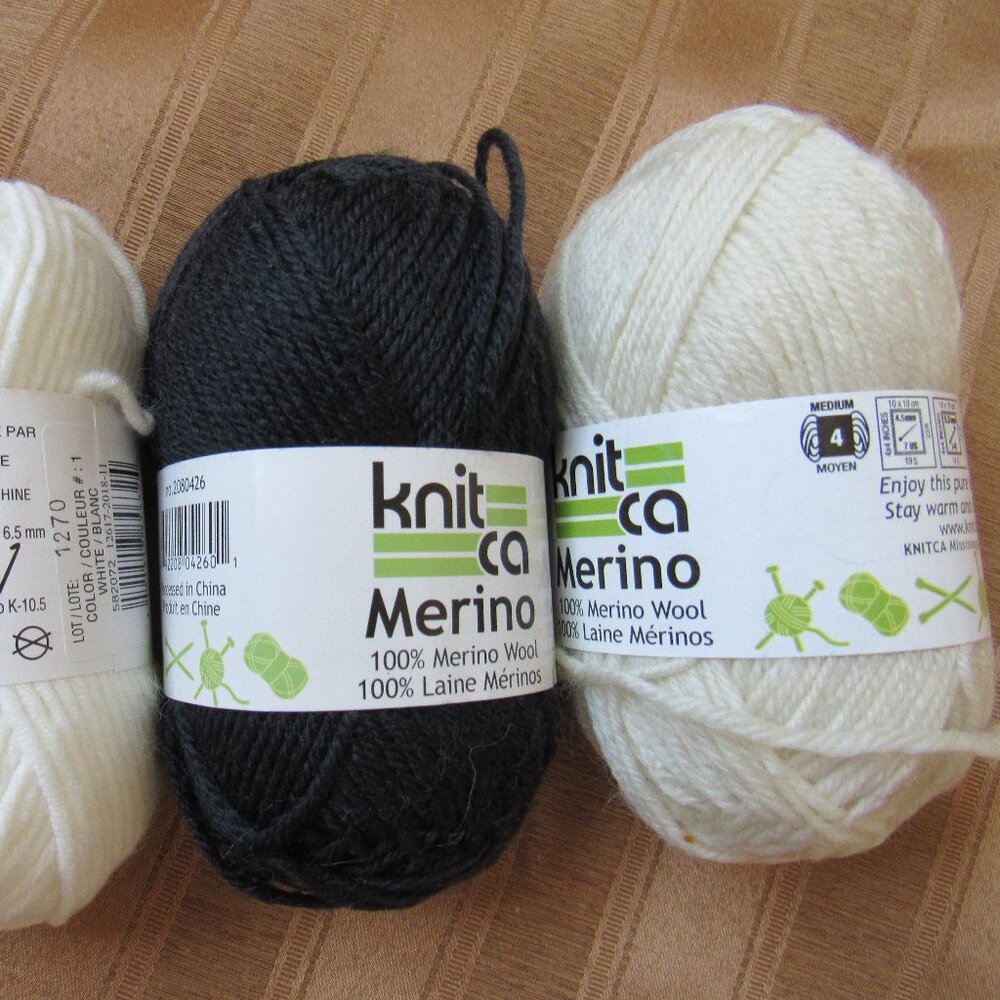 2 balls merino wool yarn, black & white & 1 ball white cotton blend yarn.